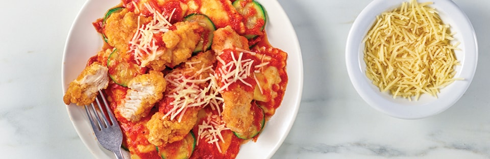 dinner plate of ravioli with chicken on top