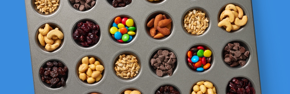 classic trail mix ingredients in muffin tin