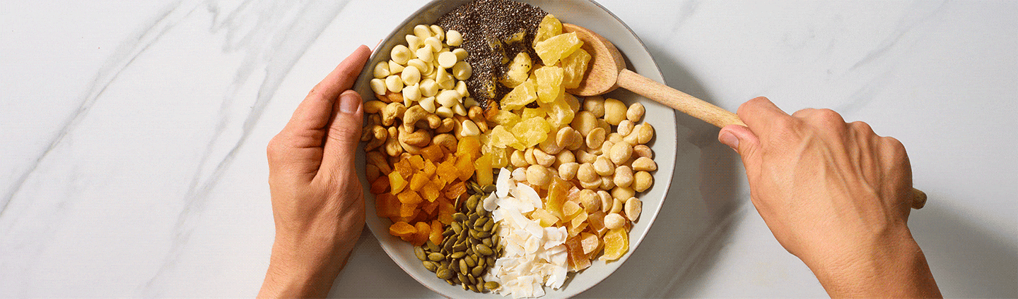 someone mixing granola ingredients