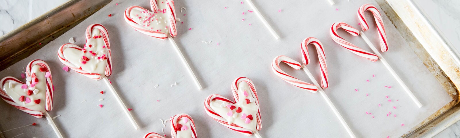 Candy cane lolipops on baking pan